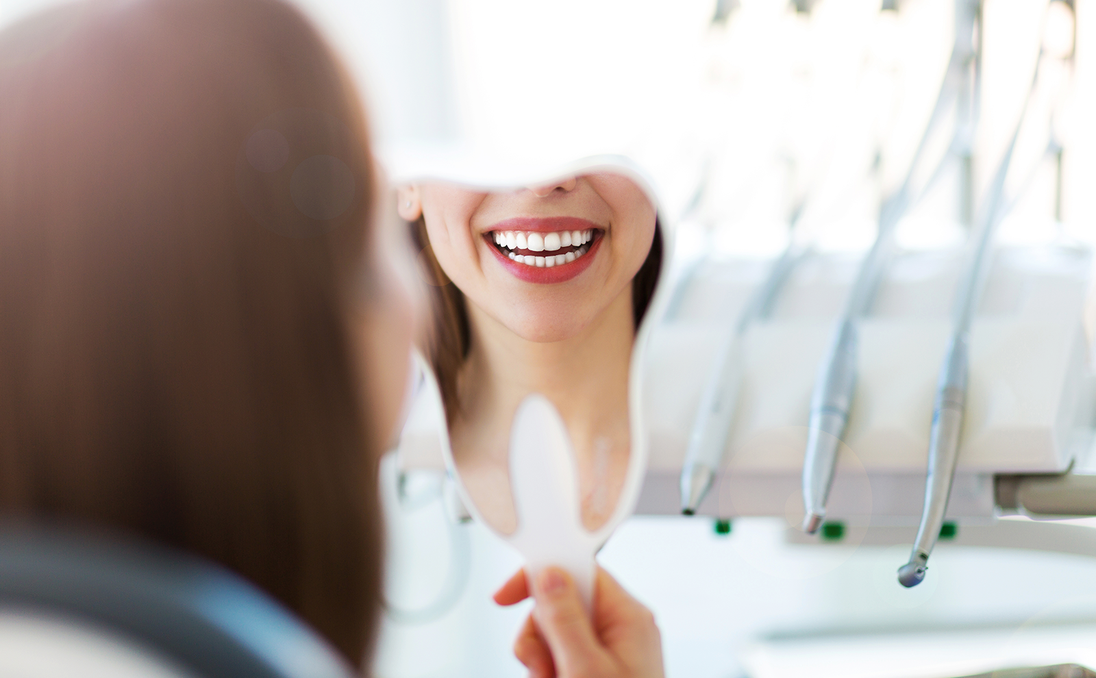 Woman looking in the mirror at her teeth